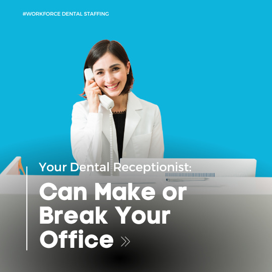 Dental receptionist in white coat answering phone at desk