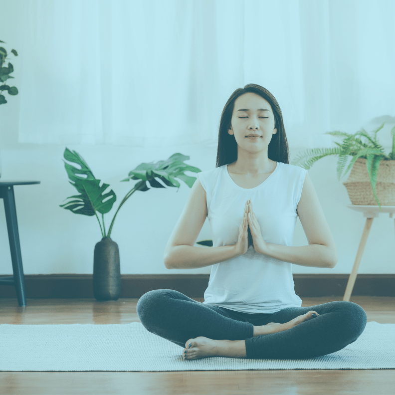 Dental office manager in yoga zen pose on yoga mat.