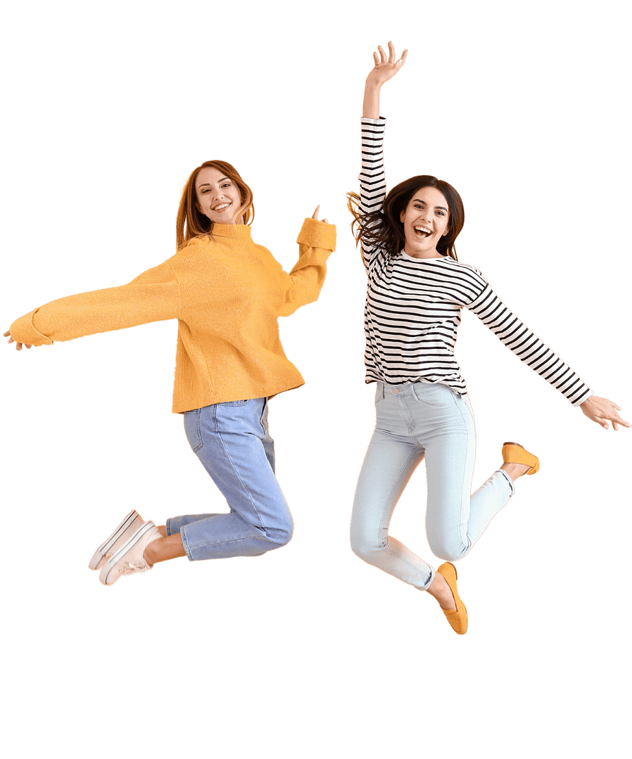 Two dental professionals in sweaters jumping in the air happily.