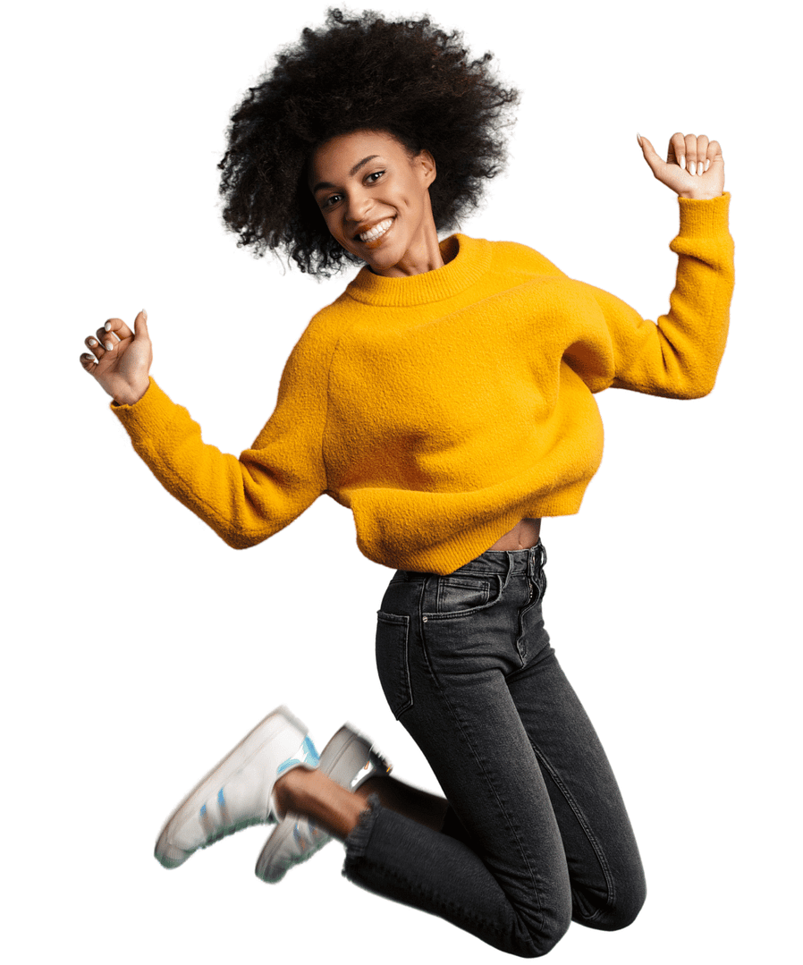 Woman in yellow sweater jumping for joy with smile on face
