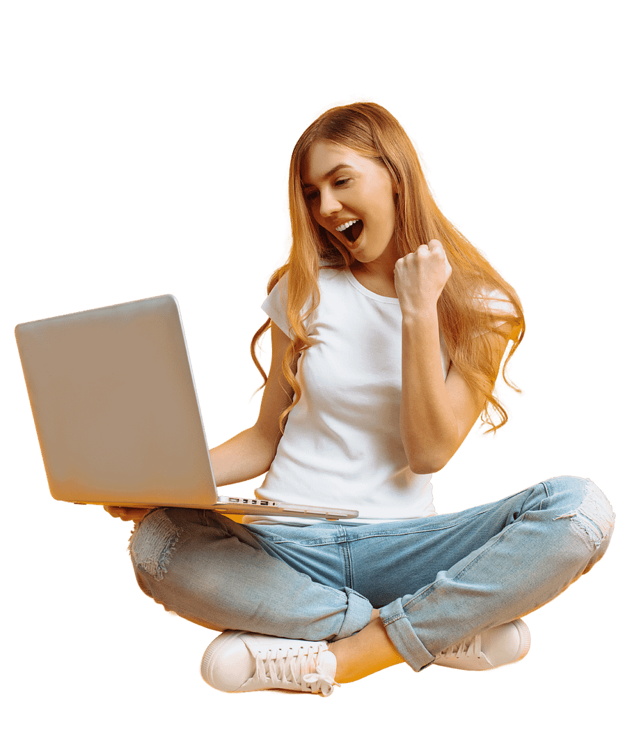 Blond girl in white shirt and blue jeans sitting crosslegged and smiling at her laptop.