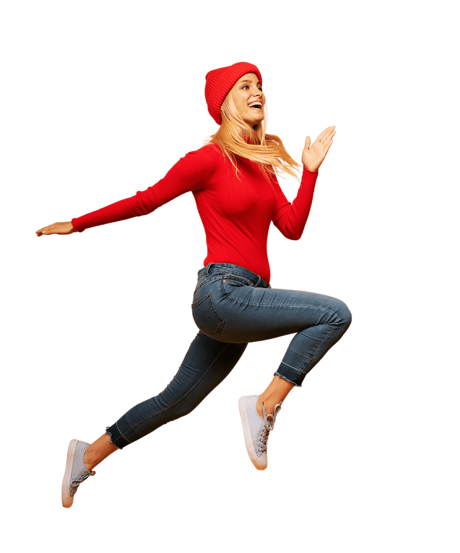girl in red sweater and red hat jumping through the air while smiling