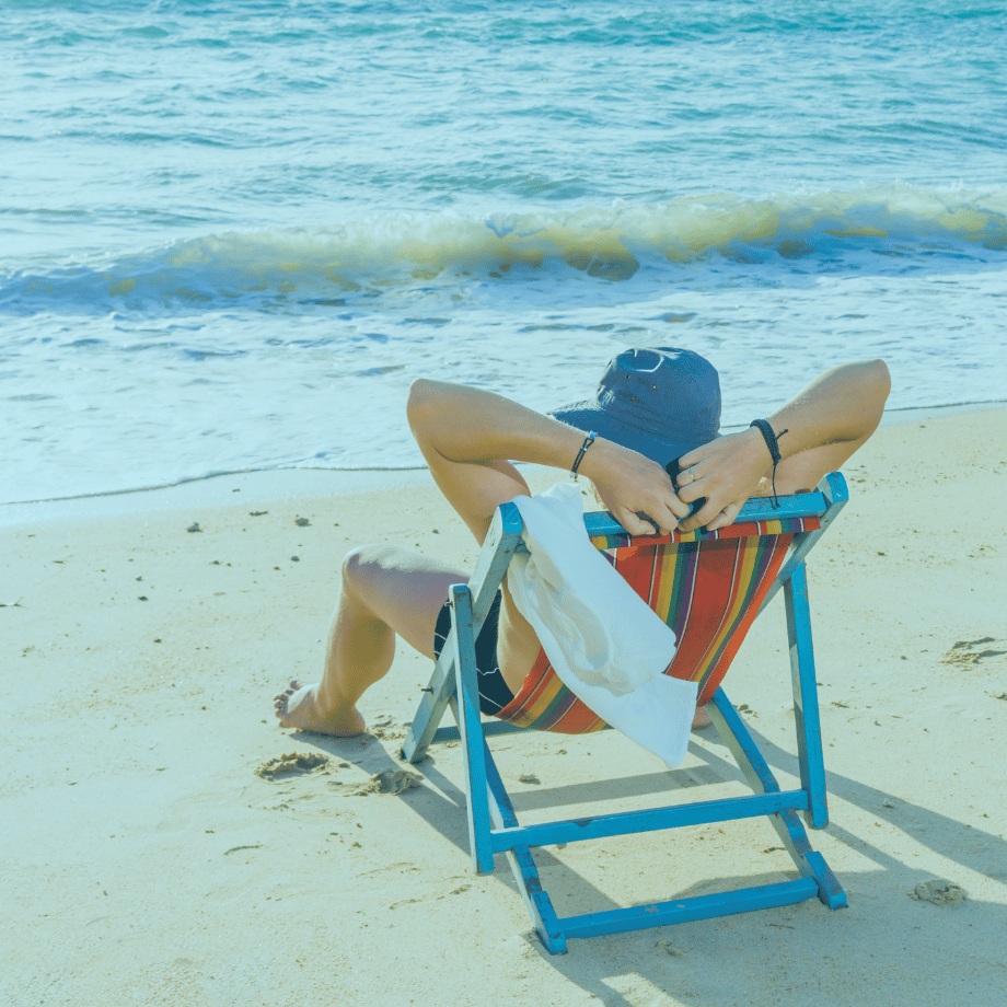 Man at beach relaxed in a foldout chair